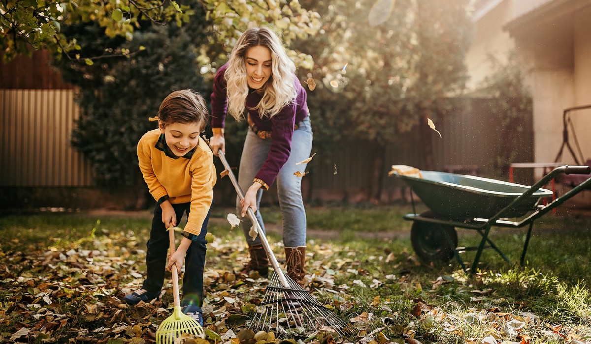 Son helping her mother in the backyard