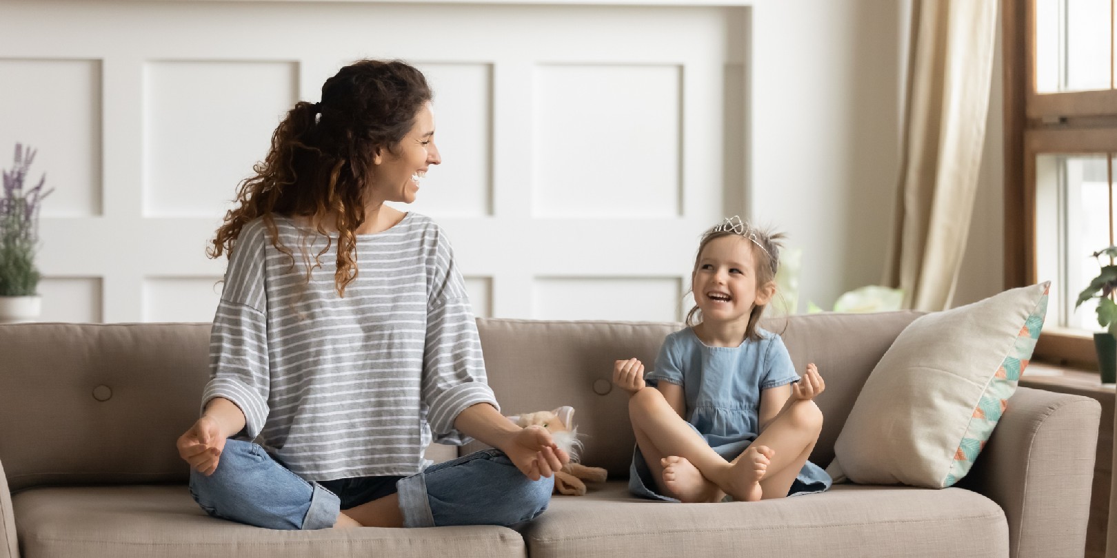 Happy mommy practicing yoga exercised with small child