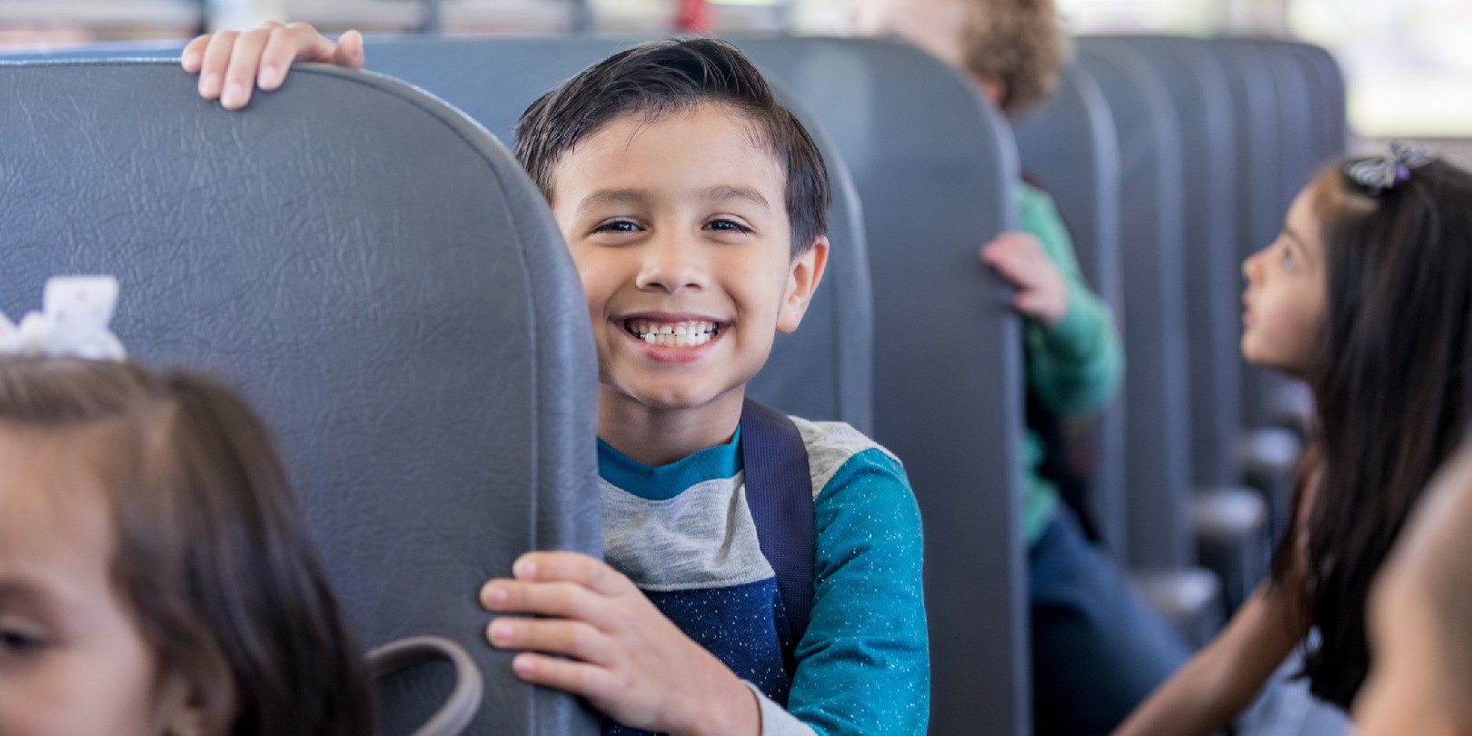field-trip-lunch-ideas mighty-moms Schoolboy smiles excitedly while sitting on school bus