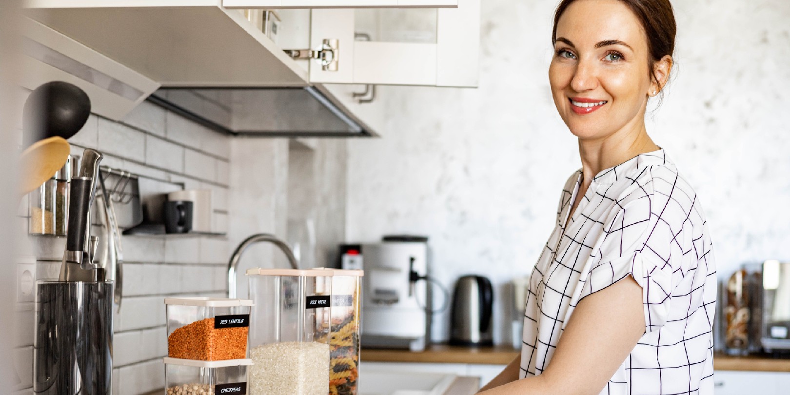 Happy woman professional space organizer smiling posing with plastic case boxes for comfortable product storage