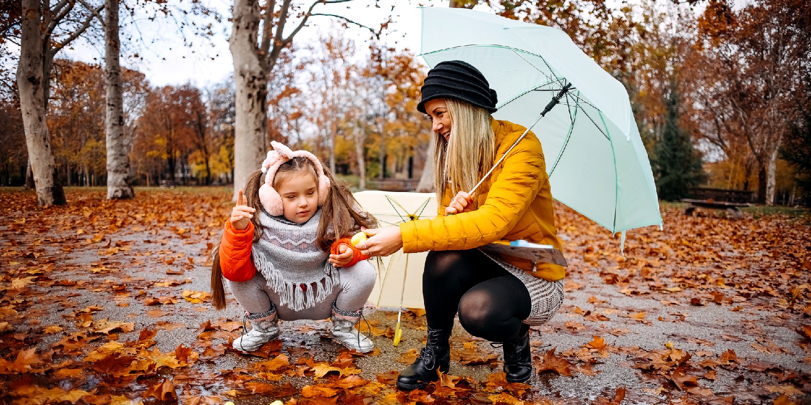 Mother and daughter enjoy a rainy day together.