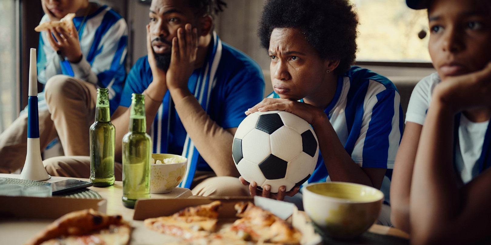 soccer-snack-ideas mighty-moms African American family feeling frustrated after their favorite soccer team has lost the match.