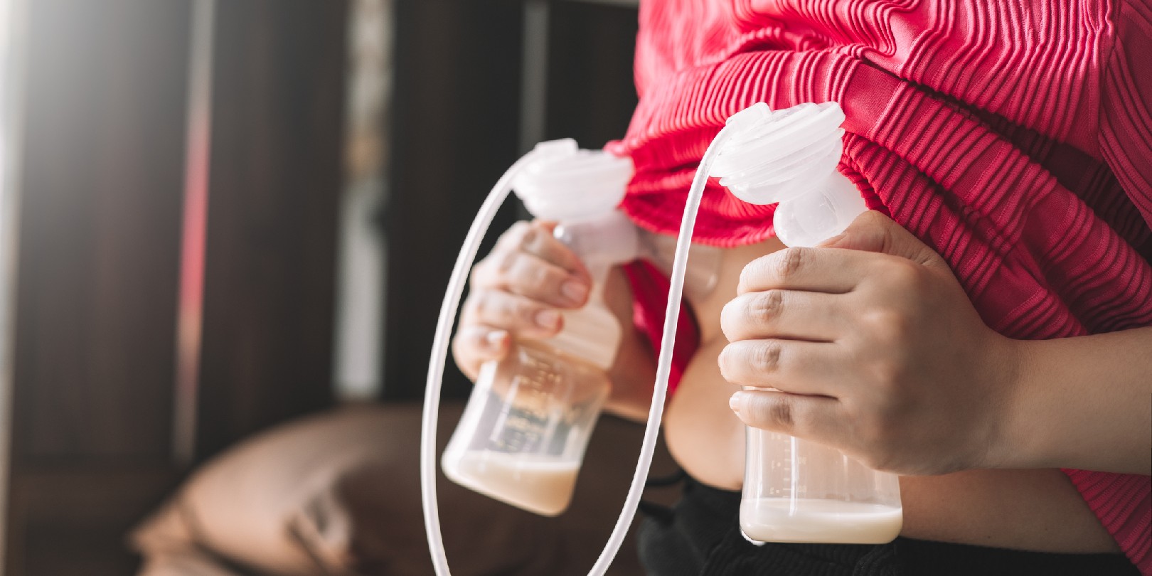 breastfeeding-vs-pumping mighty-moms Mom using breast pump machine to pumping milk for her son in bedroom. Colostrum milk, Transitional milk, Breast Pumping milk concept.