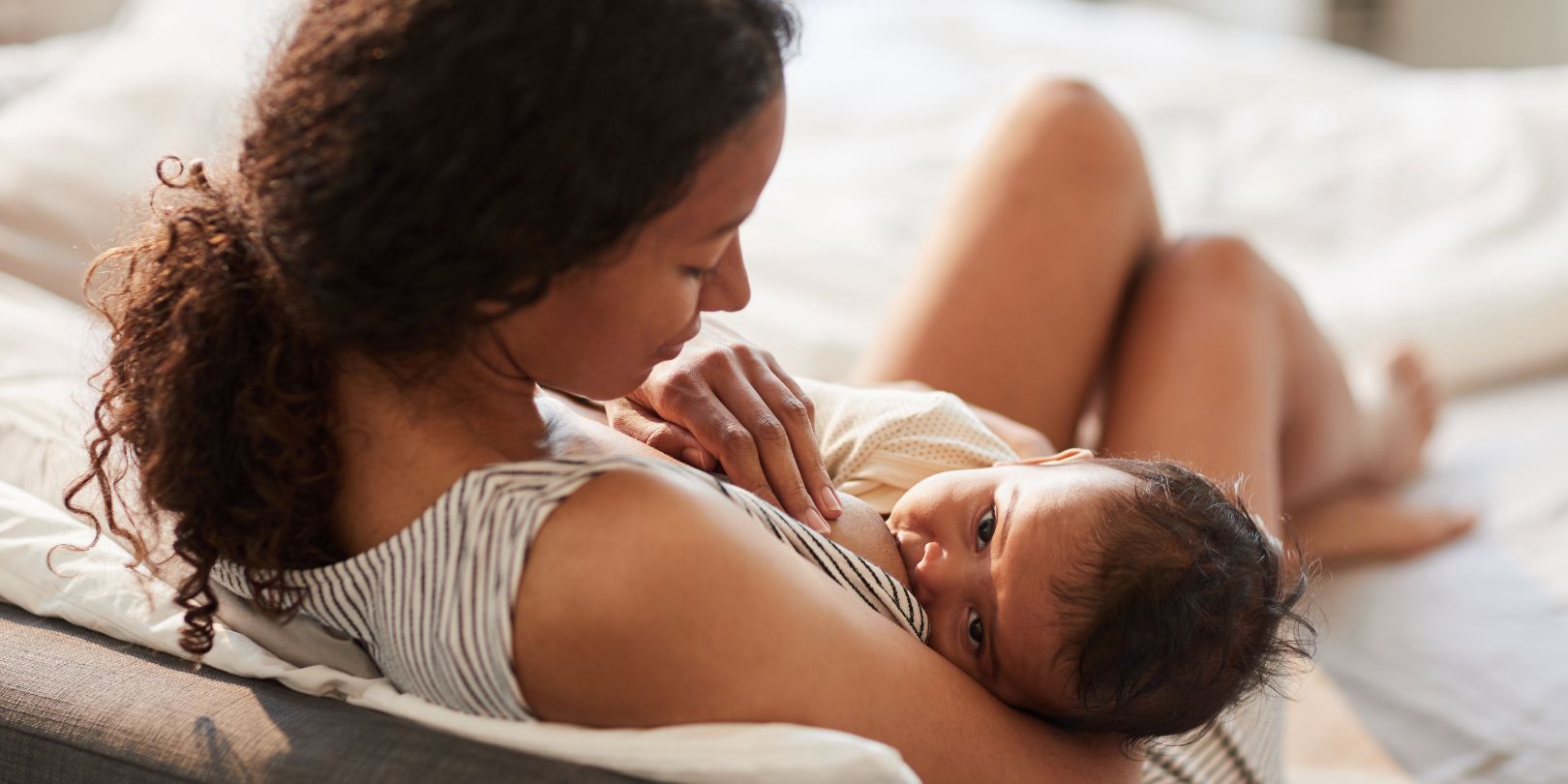 Young Mother Breastfeeding Baby Baby at Home