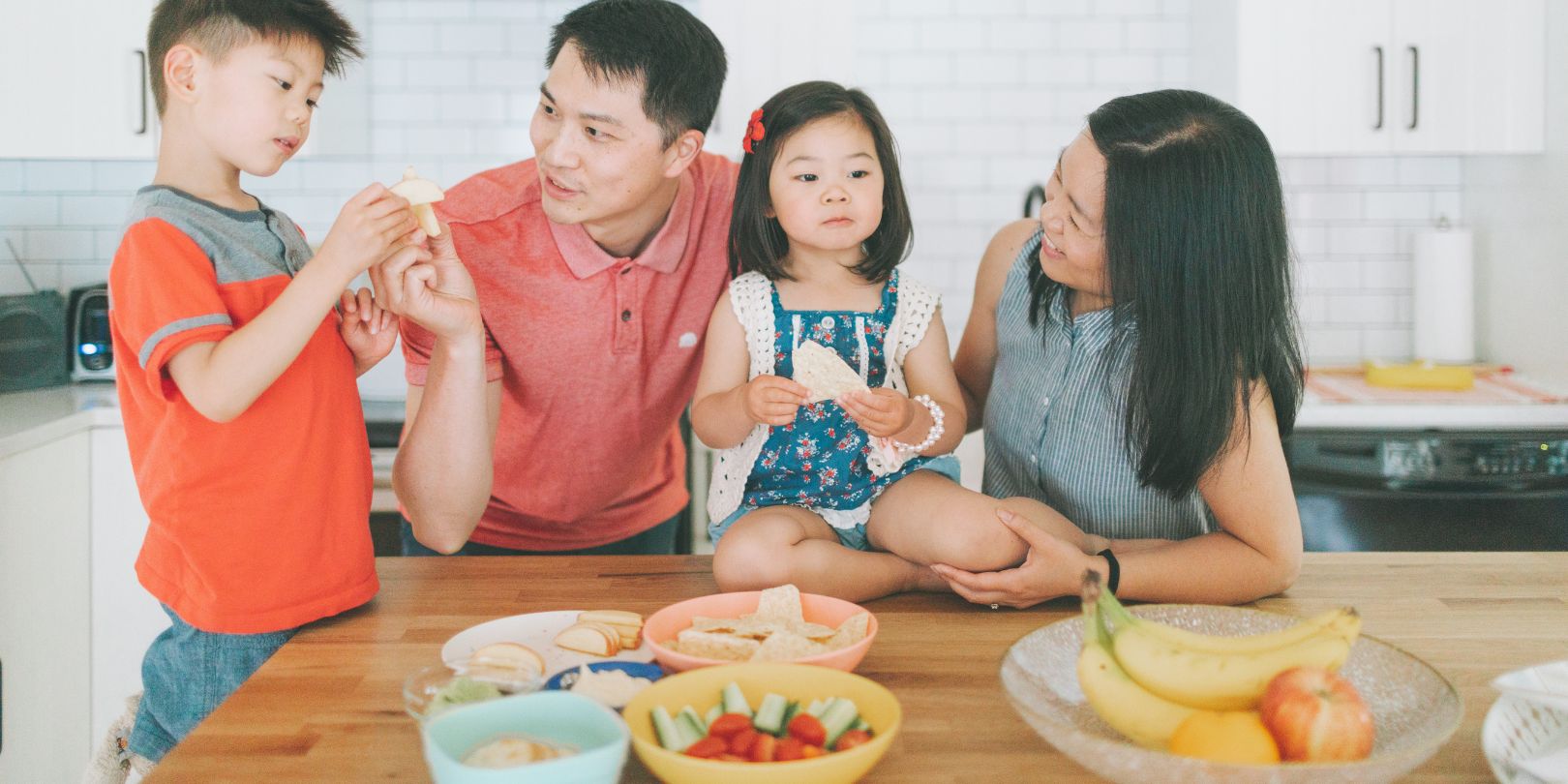 Family Eating Snacks in the Kitchen