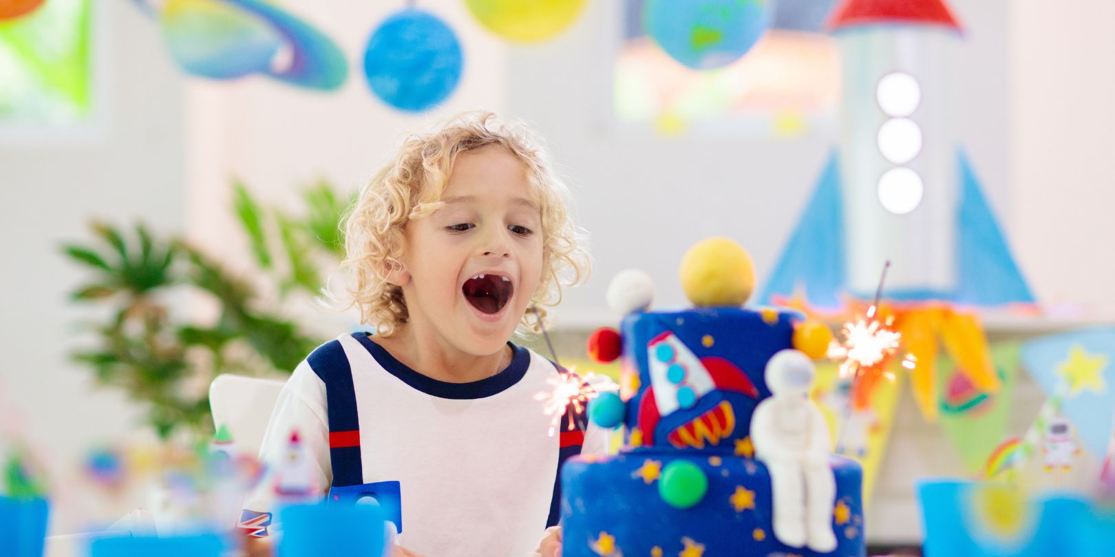 Kids space theme birthday party with cake.