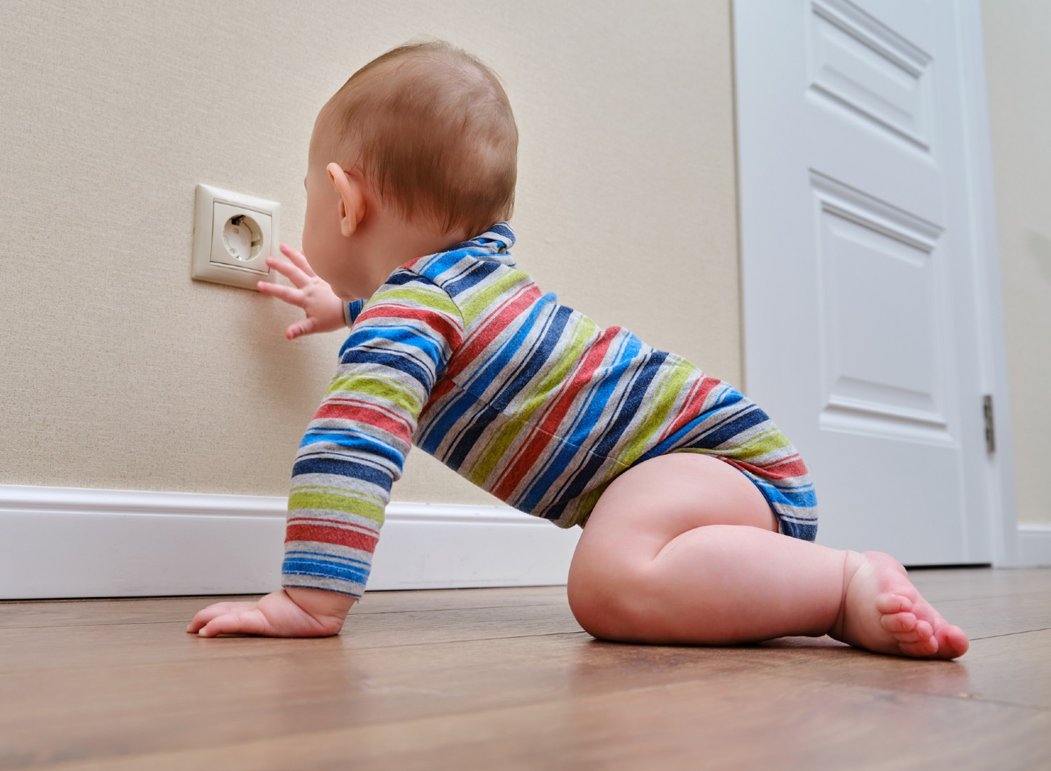 Baby reaching for an electrical outlet