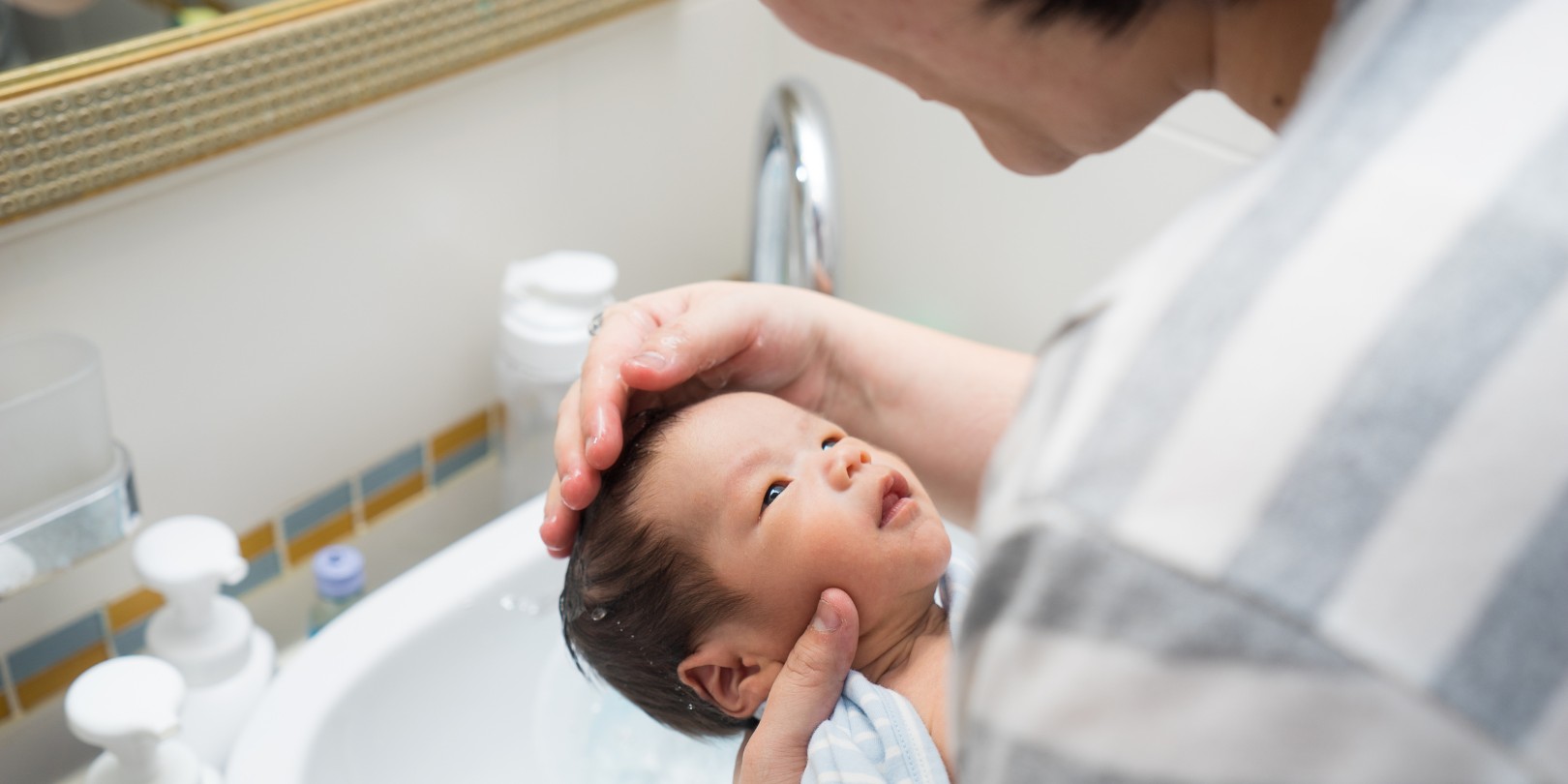 Asian newborn baby having a bath