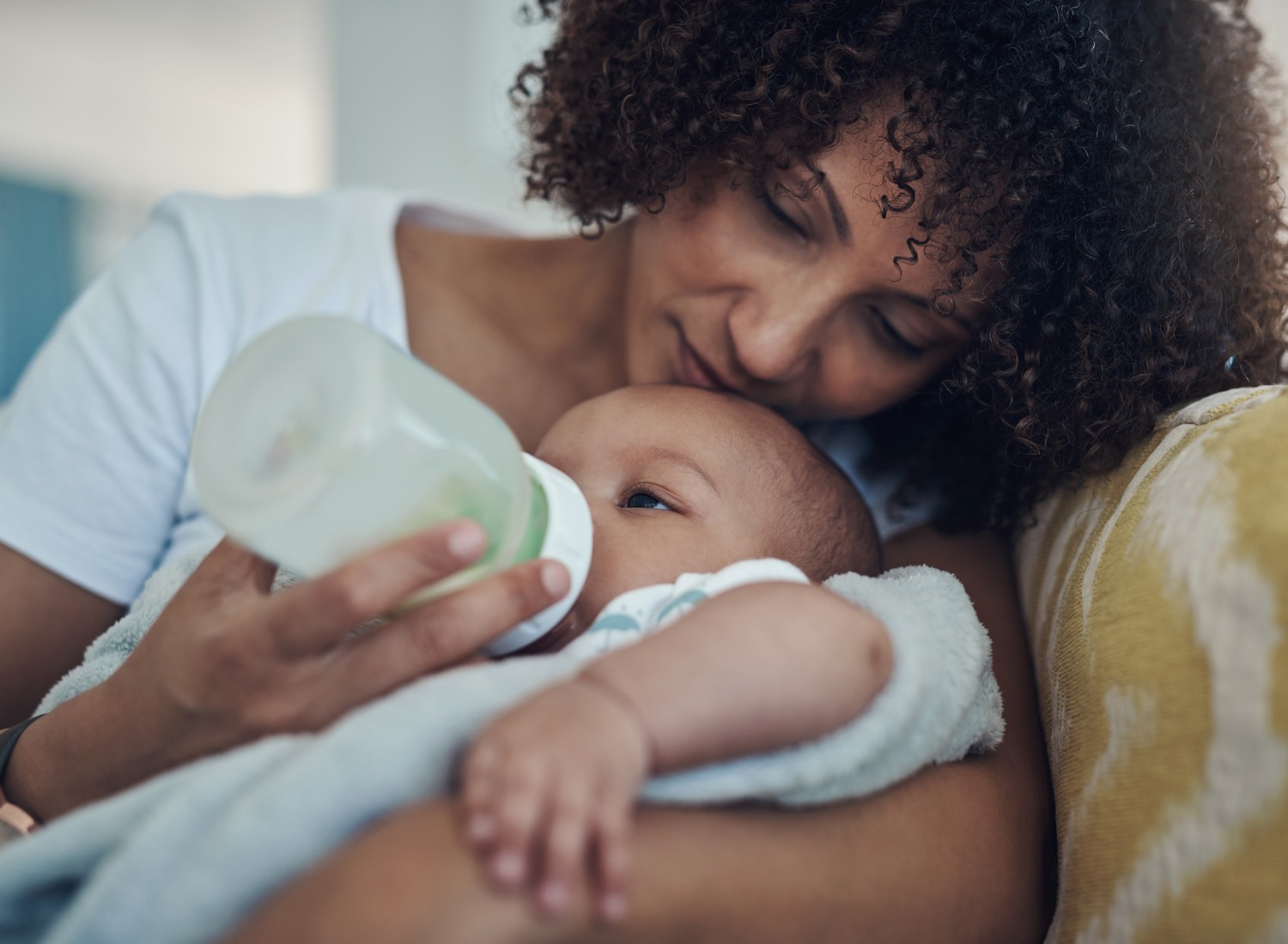 Woman feeding her baby with a bottle