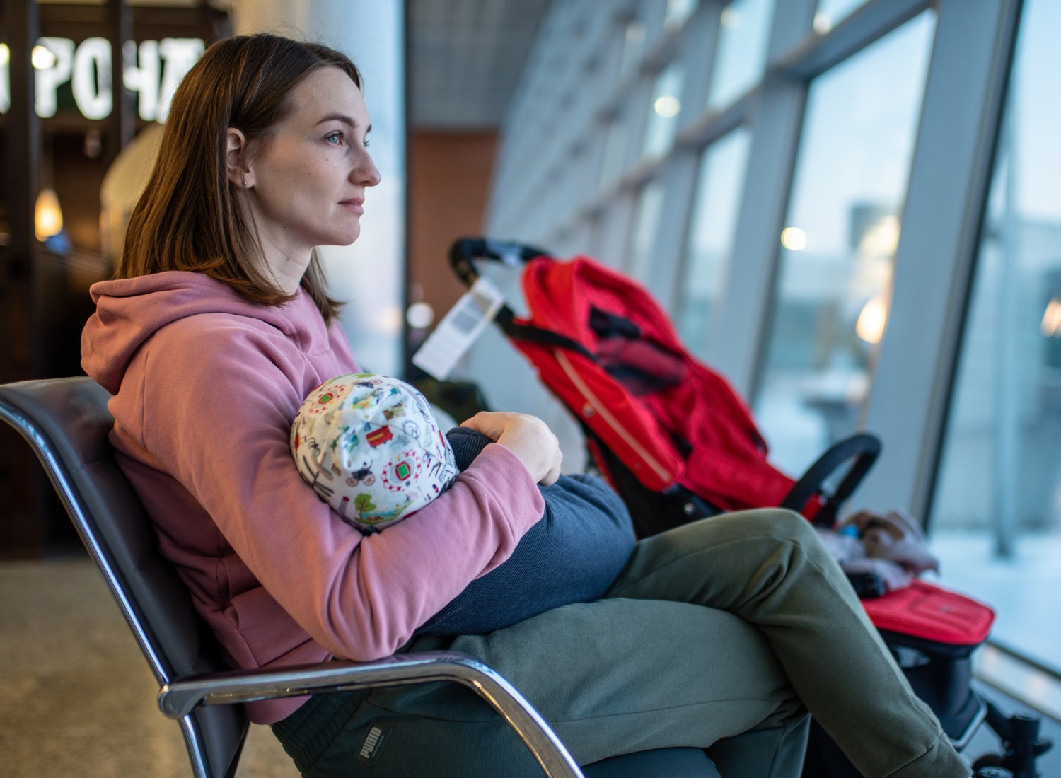 Woman holding her baby in an airport