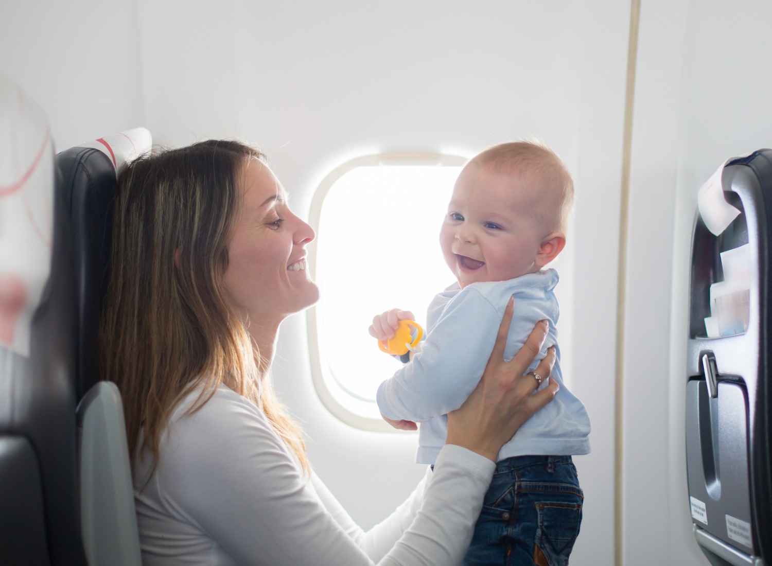 Mom playing with her baby on an airplane