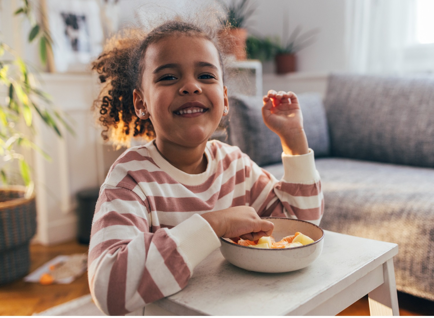 Girl eating a bowl of fruit