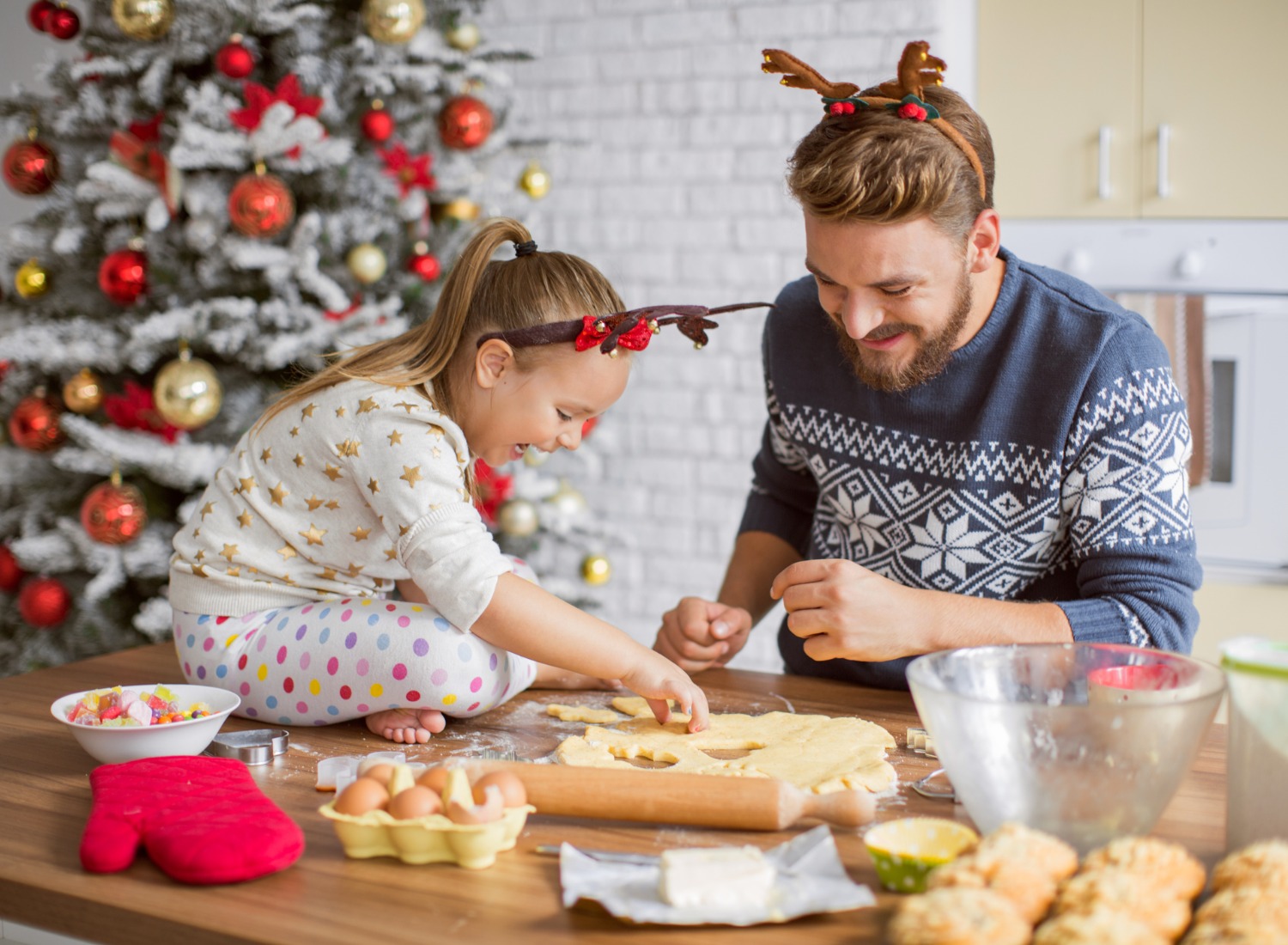 Father and daughter baking cookies