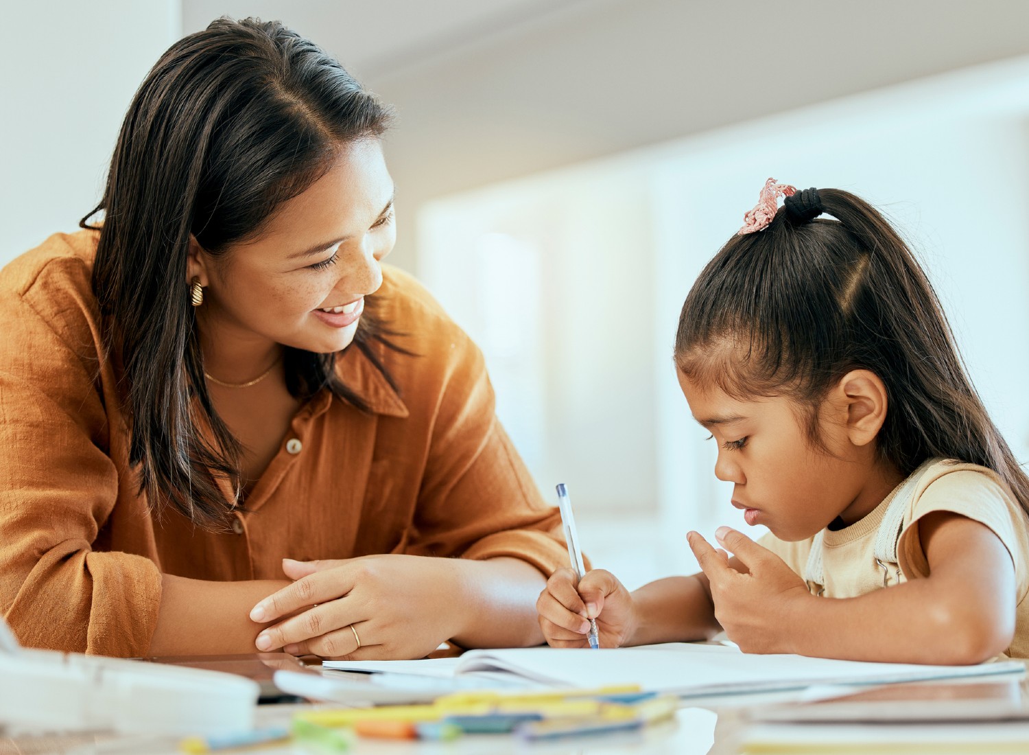 Woman homeschooling her daughter