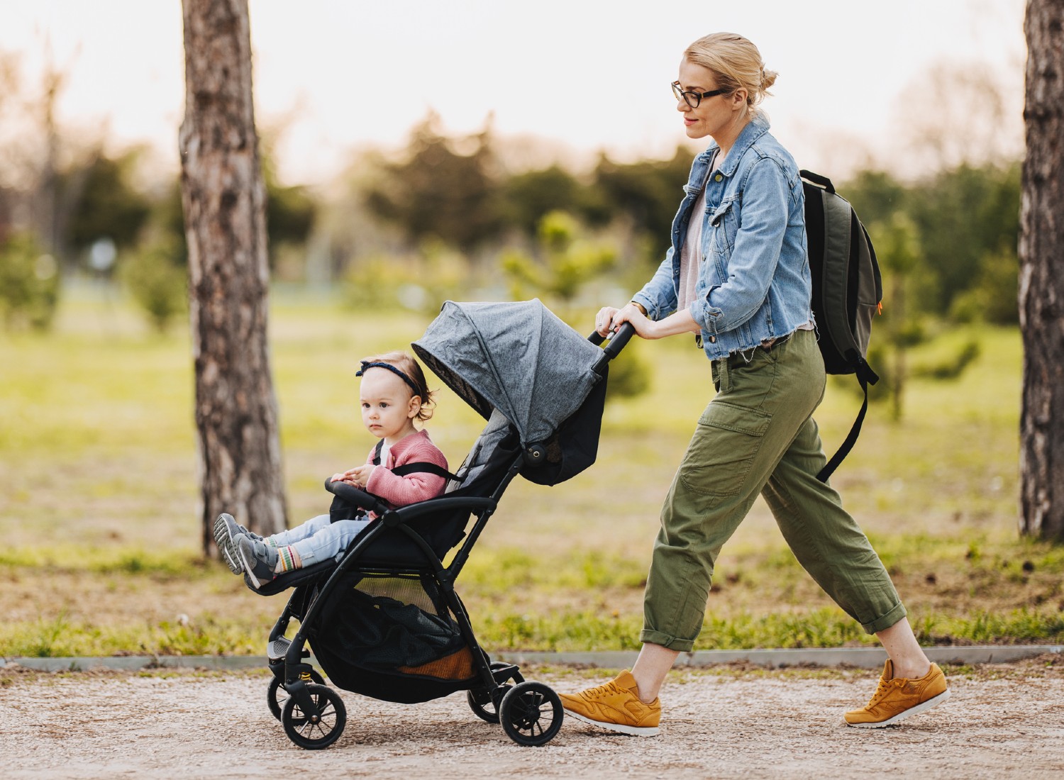 iStock-1361618651 Woman pushing a baby in a stroller