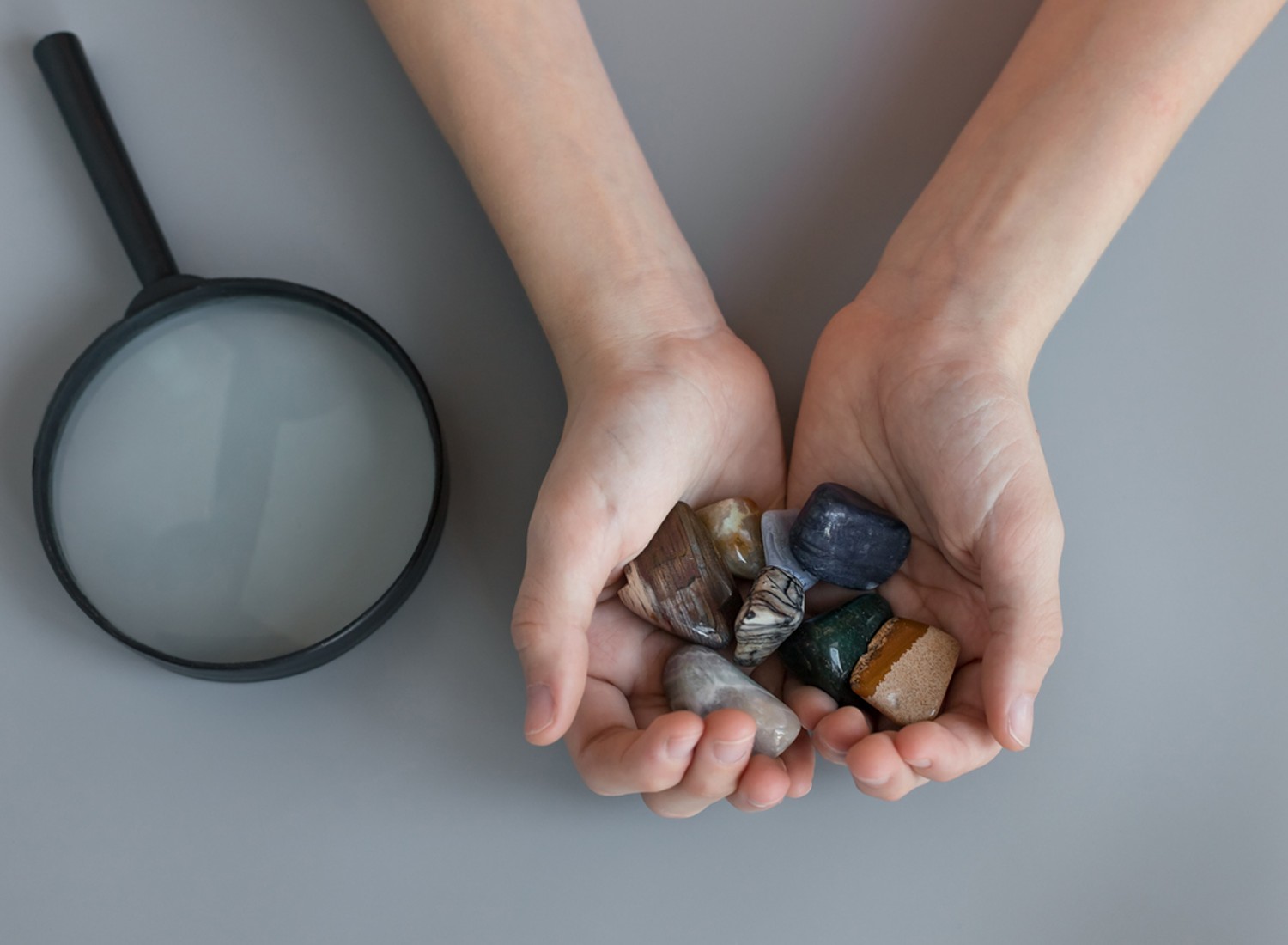 Child holding collection of rocks