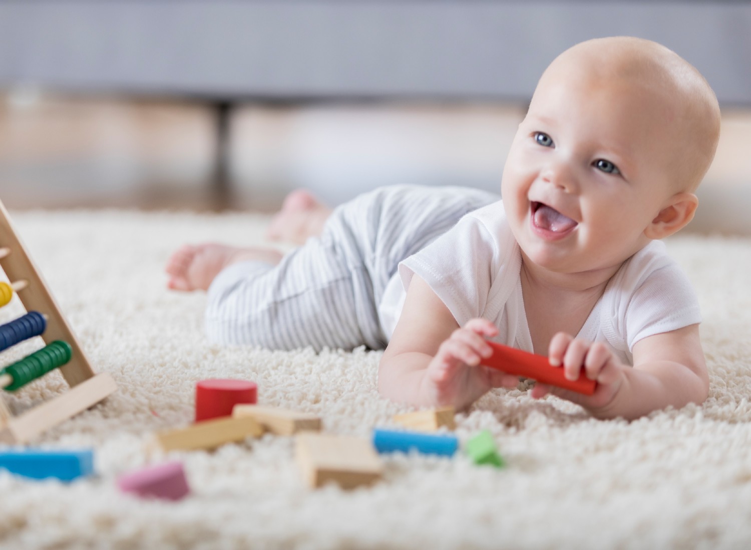 iStock-865900638 Baby playing with toys during tummy time